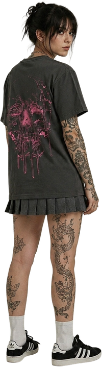 Person wearing a black t-shirt with a pink skull graphic design, standing looking back.